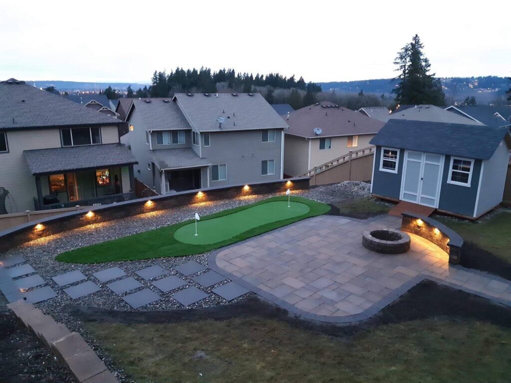 Synthetic Turf Backyard design with putting green and paver patio