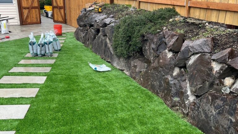 Artificial Turf and Paver Walkways in Renton, WA: 2,150 sq ft of Turf Along a Rock Wall, Stepping Stones and Scandina Grey Side Yards